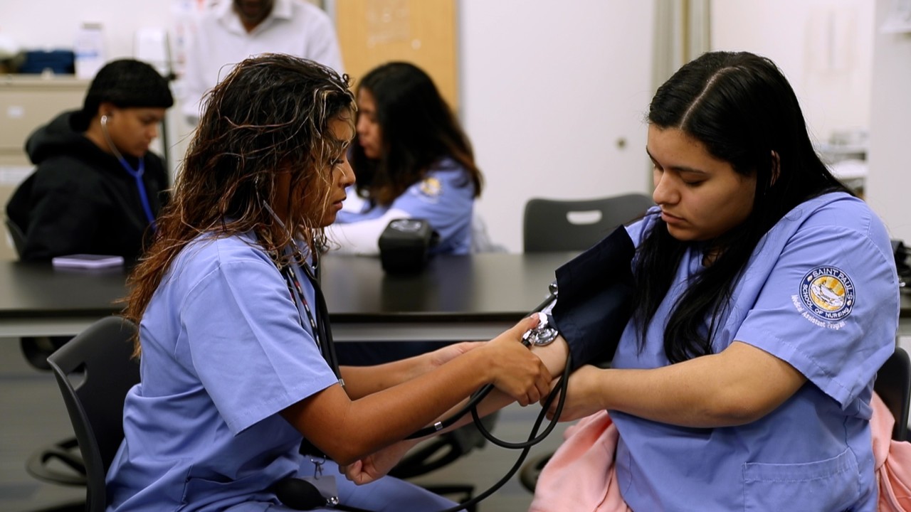 medical assistant taking blood pressure reading